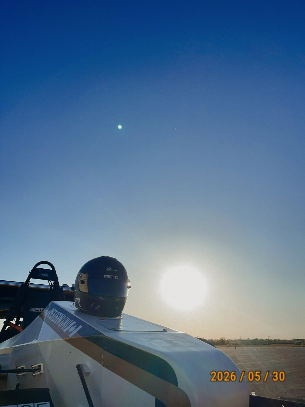Driver seated in the car at sunset